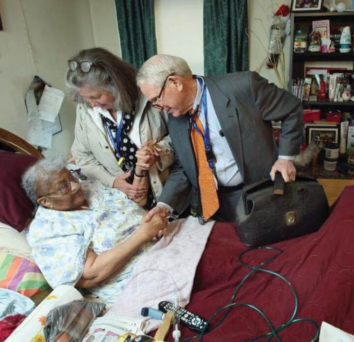 doctor and nurse at the bedside of a woman