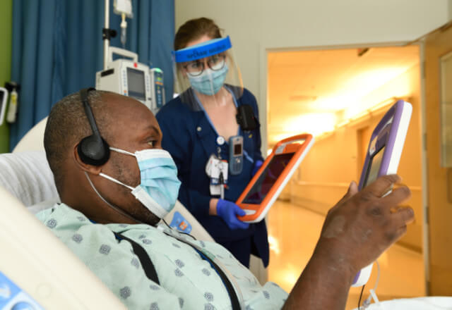 a man and nurse use a tablet