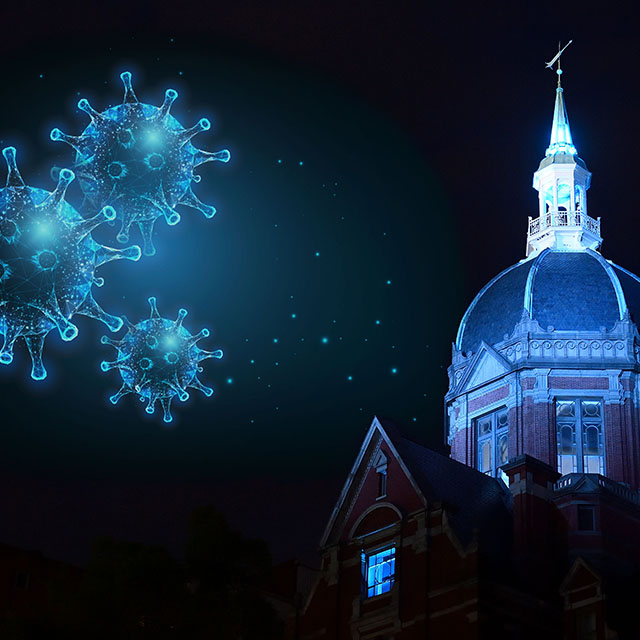 Composite photo of Glowing blue covid germs floating over the Billings building