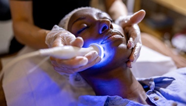 Woman receiving dermatology treatment