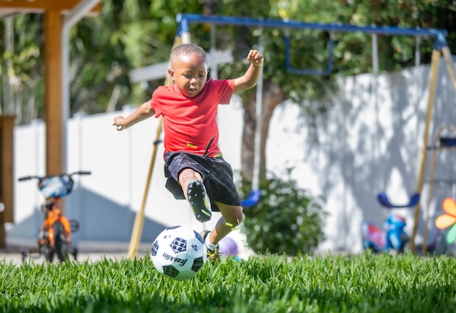 Patient Erik playing soccer outside