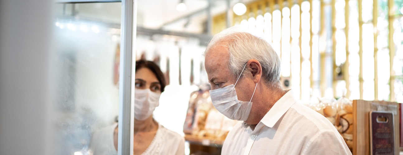 senior couple wears protective masks while shopping