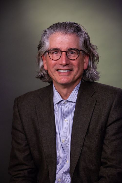 male doctor with glasses and long hair