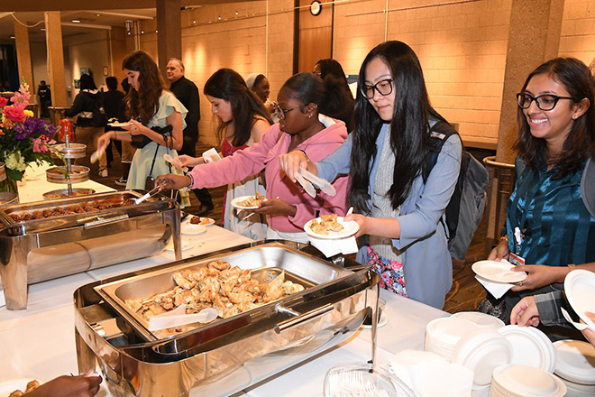 Attendees in buffet line for food