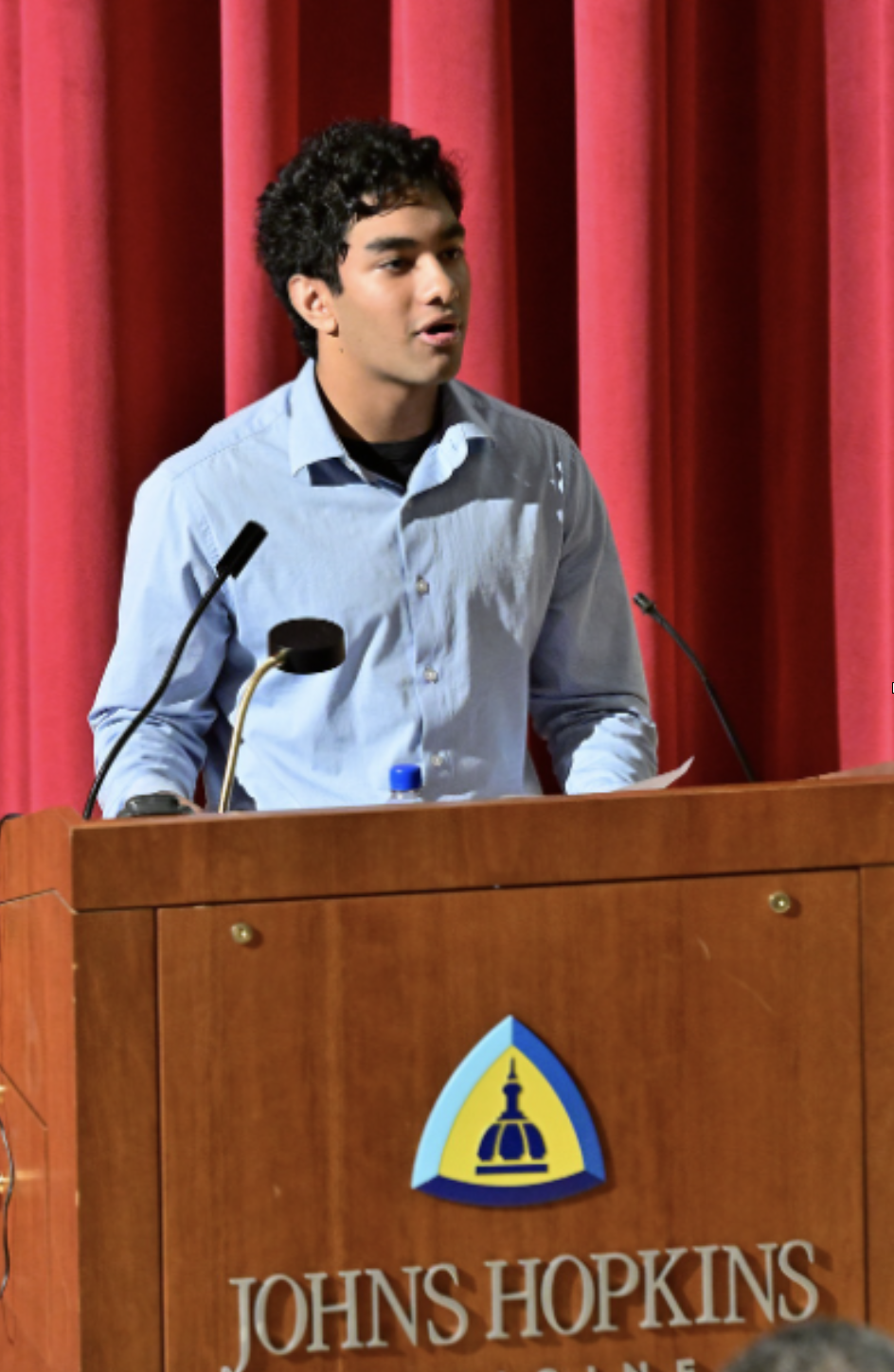 Rik Chaudhuri standing at podium