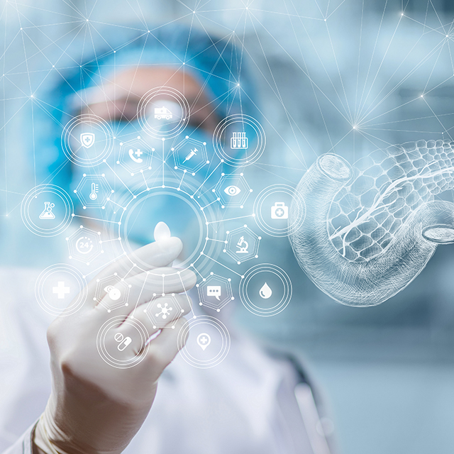 A Doctor in PPE holding a seed shaped digital object. Around that object is a digital pancreas and other medical symbols. 