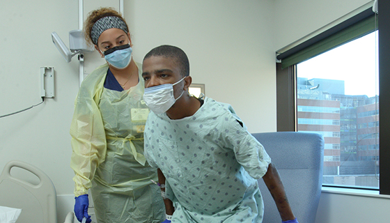 A patient at The Johns Hopkins Hospital moves to his highest level of mobility following the JH-AMP program