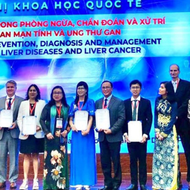 This picture is from a conference held June 11–12 in Ho Chi Minh City, in collaboration with the HCMC Medical Association and the University of Medicine and Pharmacy at HCMC. There were 350 physicians participating on-site and another 400 physicians online. Doan Dao and James Hamilton, from Johns Hopkins, are pictured fifth and seventh from left, respectively.