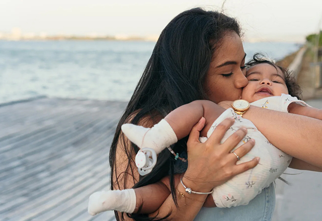 mother kissing baby