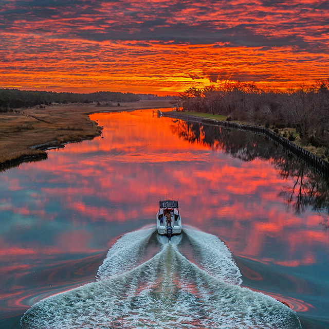 boat on water at sunrise