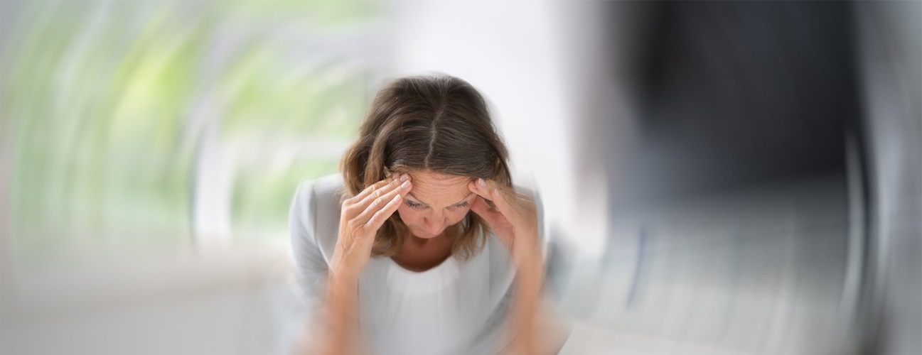 Woman experiencing dizziness. 