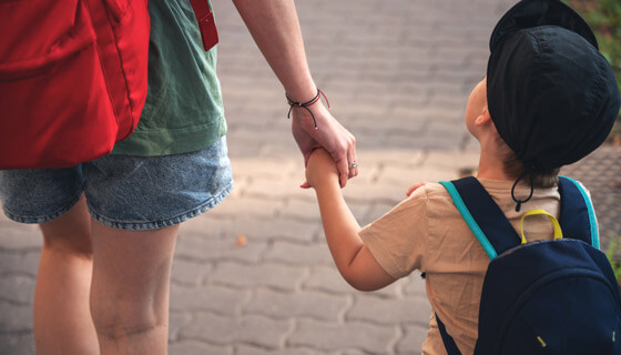 Child holds hand of adult