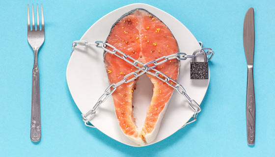 Poisonous fish on a plate blocked by a chain and lock