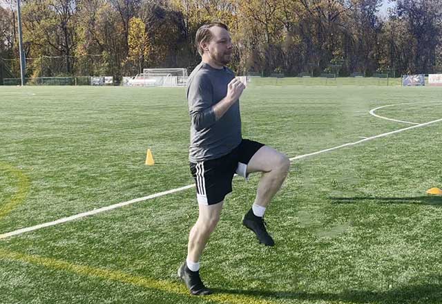Image of John performing a high knee jog.