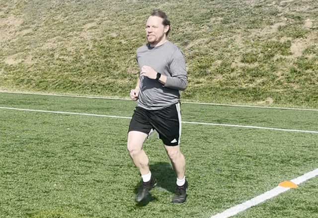 Image of Jimmy jogging in the soccer field.