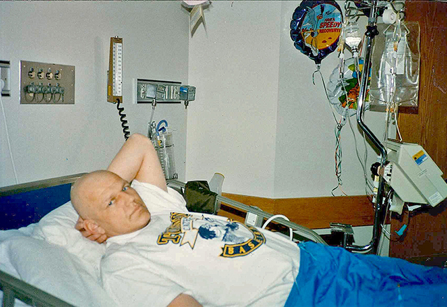 Richard laying in hospital bed. 
