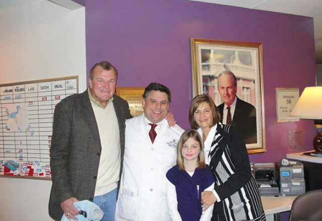 Rhineharts with grandaughter and Dr. Ambinder in a group photo smiling.