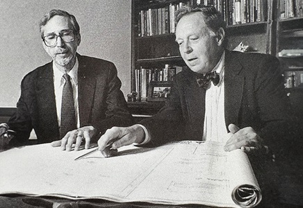 Abeloff and Owens looking at building plans together.