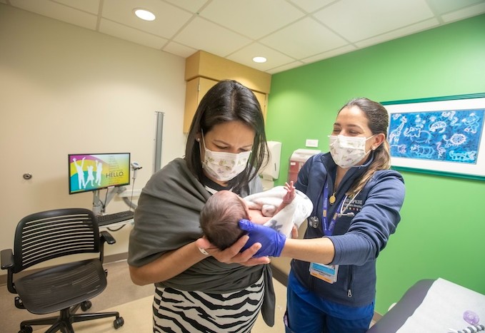 Resident physician with patient and mom