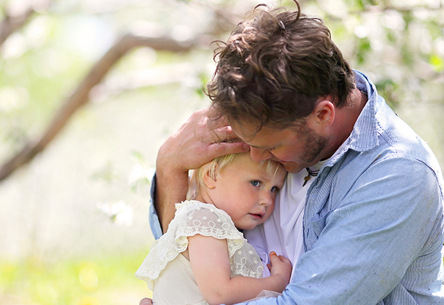 Father hugging a young child.