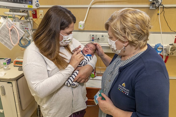 John-Derrick and his mother Anna with nurse practitioner Carolyn Kelly, APRN.