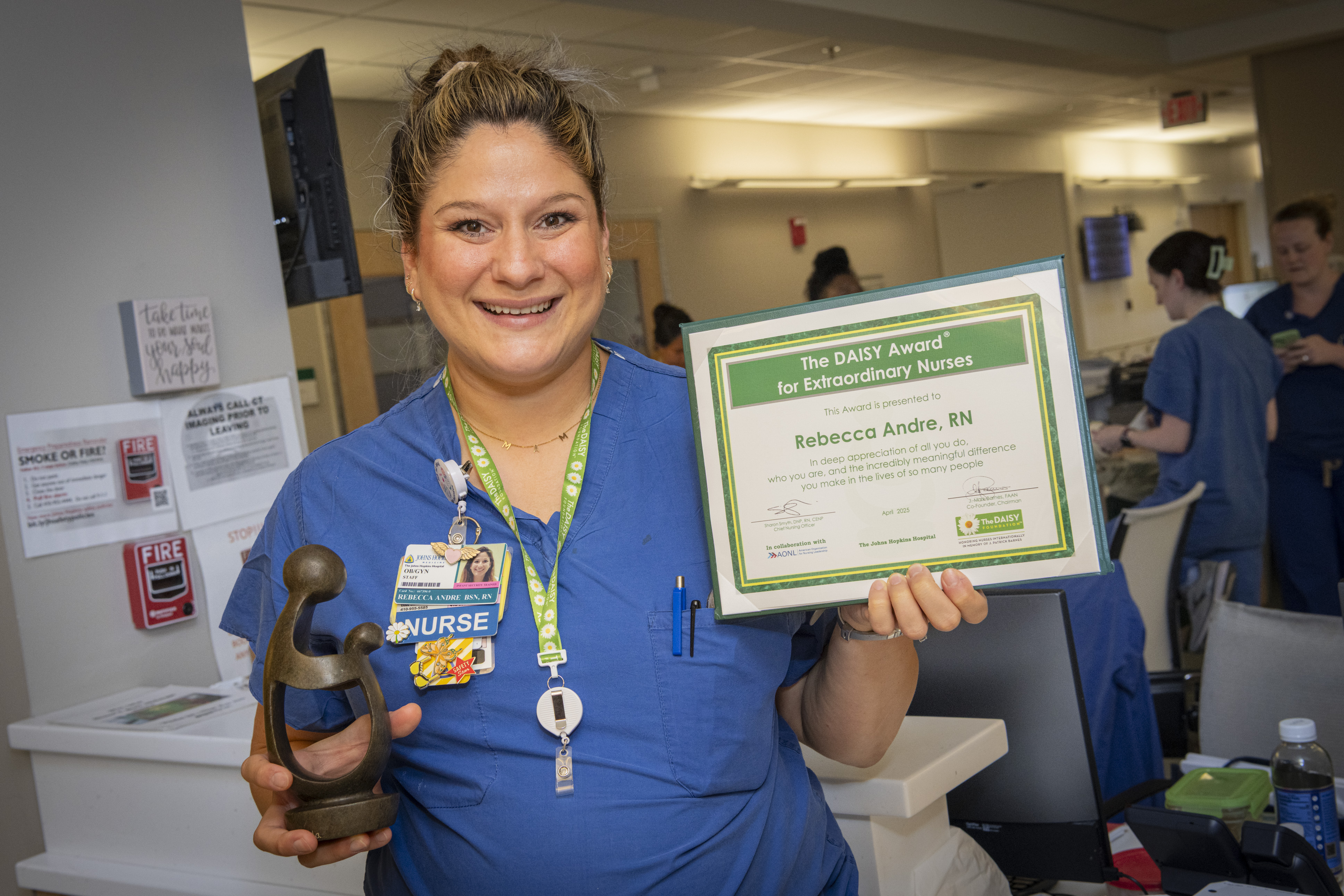 Rebecca Andre holding her DAISY award