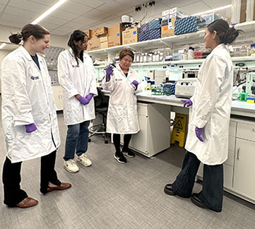 Wanli Smith and team in lab coats