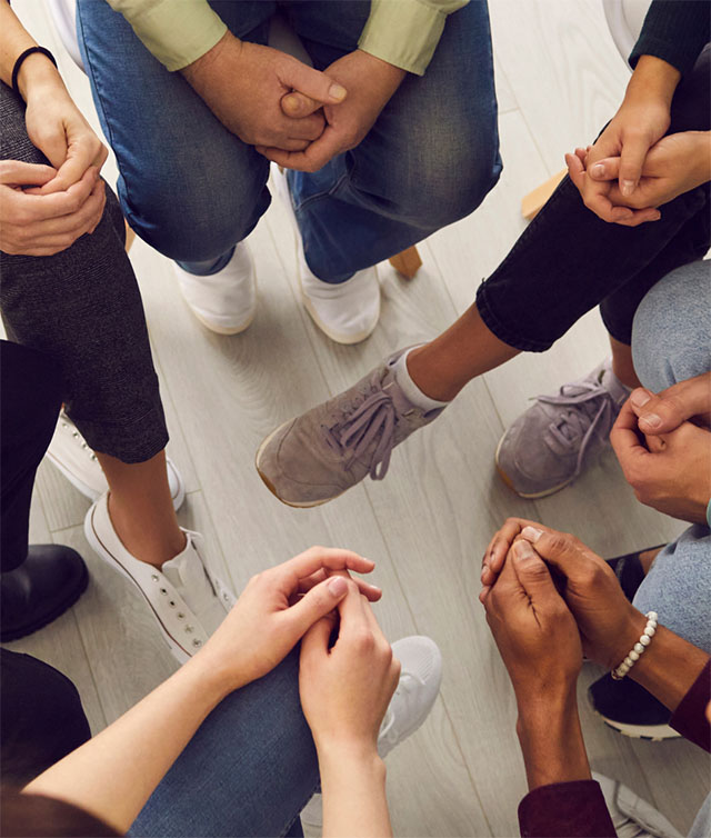 A group sitting in a circle - arms and legs