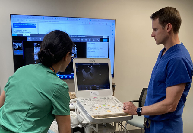 Two students looking at imaging report