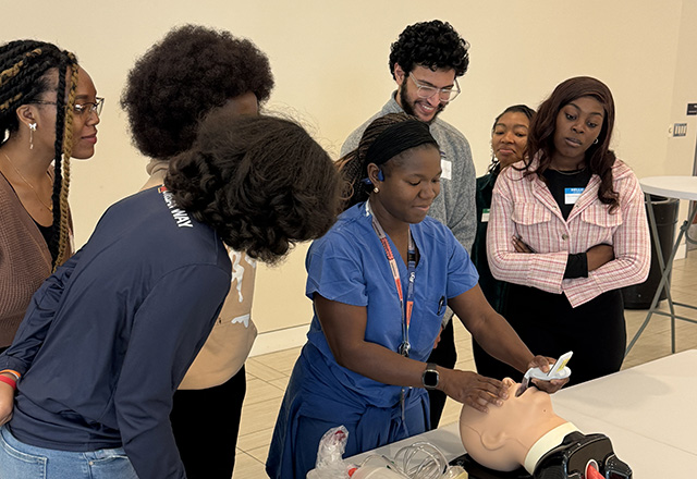Students practicing medicine on a dummy