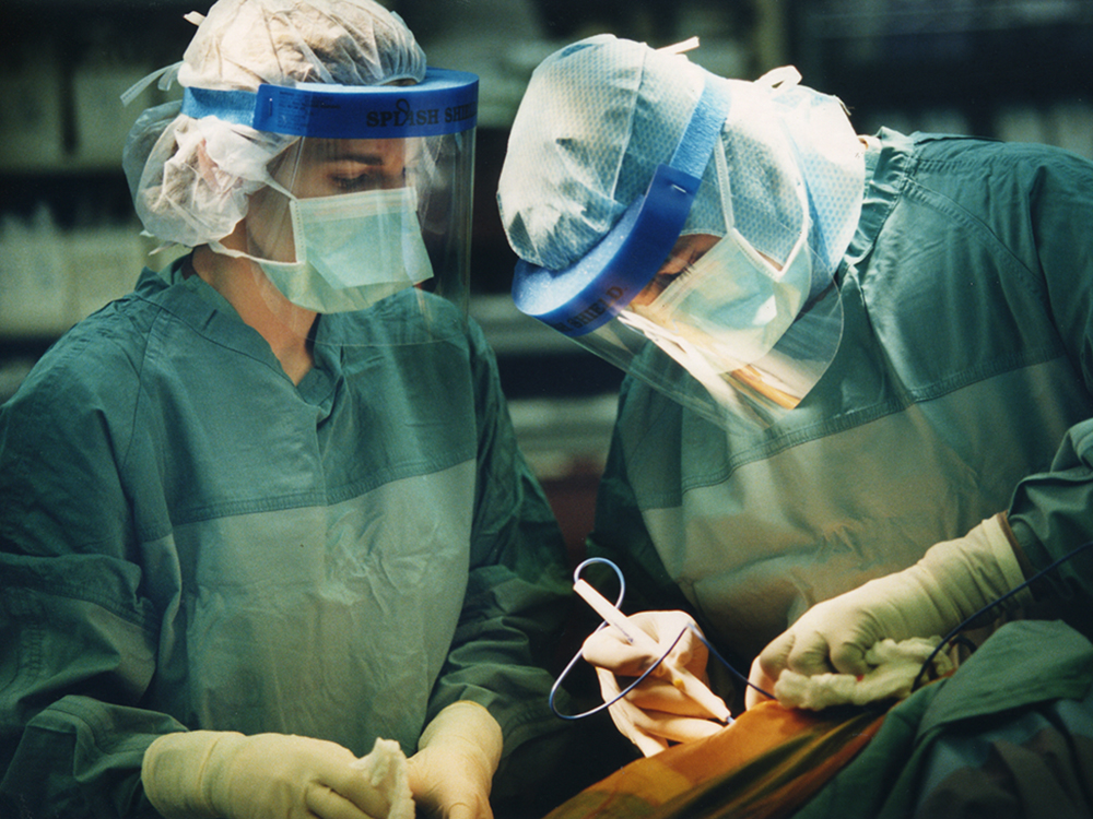Surgical staff performing hip surgery