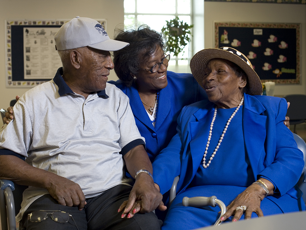 Elder couple with a caregiver