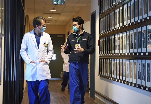 Dr. Redett walking down the halls with a fellow.