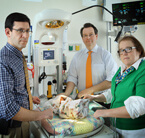 Pediatric neurologist Adam Hartman, neuroradiologist Thierry Huisman and neonatologist Frances Northington, co-directors of the NICN, consult over the care of a newborn