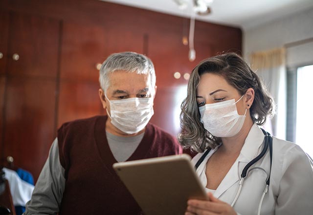 Physician showing patient her tablet