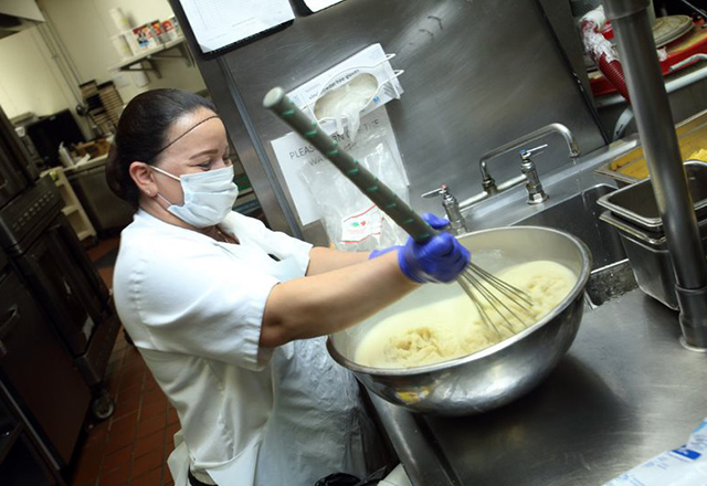 Miriam Zapeda whisking dough mixture on a bowl