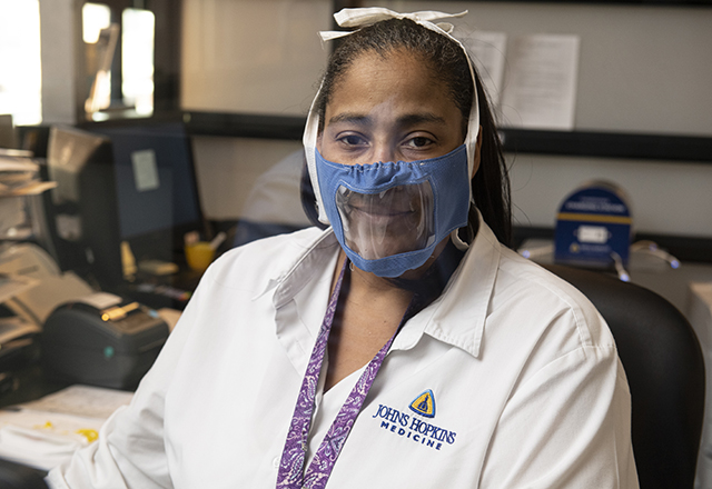 staff wearing plastic face mask