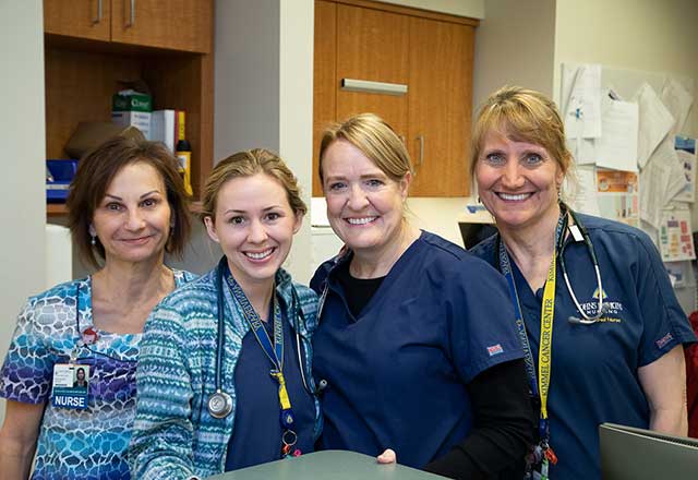 Four smiling nurses.