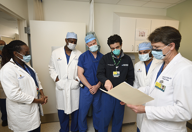 Dr. Redett speaks with fellow physicians.